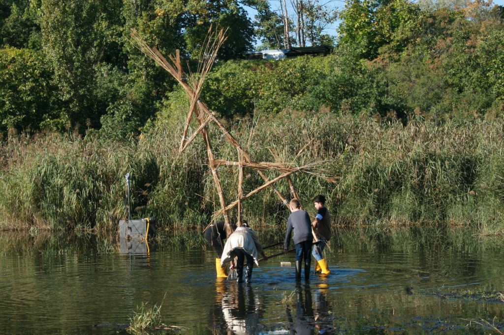 kids working on "big deer "with reeds in Floating University